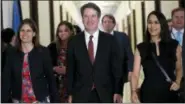  ?? JACQUELYN MARTIN — ASSOCIATED PRESS ?? Supreme Court nominee Judge Brett Kavanaugh, center, arrives for a meeting with Sen. Jim Inhofe, R-Okla., on Capitol Hill in Washington on Thursday.