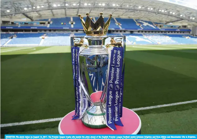  ?? — AFP ?? BRIGHTON: File photo taken on August 12, 2017. The Premier league trophy sits beside the pitch ahead of the English Premier League football match between Brighton and Hove Albion and Manchester City in Brighton. Premier League clubs will ask players to take a combinatio­n of pay cuts and deferrals amounting to 30 percent of their salary due to the financial crisis caused by coronaviru­s.