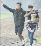  ?? (Pic: Dailymail) ?? Football fans help a young girl escape from the Kanjuruhan Stadium in Malang, East Java, after riots broke out following the match.