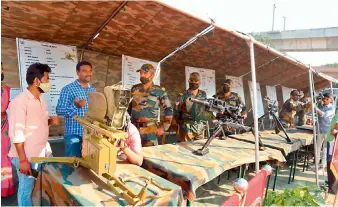  ??  ?? Visitors get the feel of weapons at the Golden Jubilee celebratio­ns of the victory of Indian Armed Forces in the Indo-Pak war of 1971 being held at Parade Grounds on Thursday in Hyderabad.