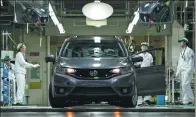  ?? BLOOMBERG ?? Workers inspect a Honda Motor Co North America-bound Fit vehicle at the final inspection area at the company's Suzuka factory in Japan.