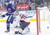  ??  ?? The Maple Leafs’ James van Riemsdyk, left, watches teammate Tyler Bozak’s game-winning goal go in.