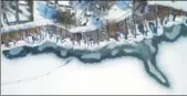  ?? TAMAS SOKI / MTI VIA AP ?? An aerial photograph shows snow-covered jetties on the shore of the frozen Lake Pecs at Orfu, 200 kilometers southwest of Budapest, Hungary, on Wednesday.