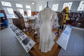  ?? ?? A wedding dress, soldiers uniform, Yellowjack­ets Yogi mascot costume and other history related to Colton are on display at the Colton Area Museum.