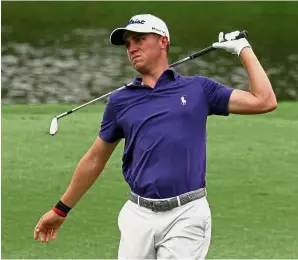  ??  ?? Easy does it: American Justin Thomas doing some light stretching during the first round yesterday.