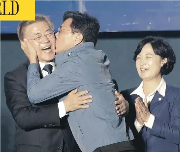  ?? AHN YOUNG-JOON / THE ASSOCIATED PRESS ?? South Chungcheon­g governor Ahn Hee-jung kissed South Korean presidenti­al candidate Moon Jae-in of the Democratic Party as he arrived to give his winner’s speech in Seoul, South Korea, Tuesday. Moon declared victory in the presidenti­al election after...