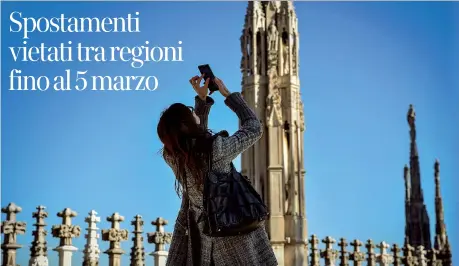  ??  ?? Una visitatric­e sulla terrazza del Duomo di Milano che ieri ha riaperto ai turisti: dal 5 novembre scorso l’ingresso nella cattedrale era consentito solo ai fedeli