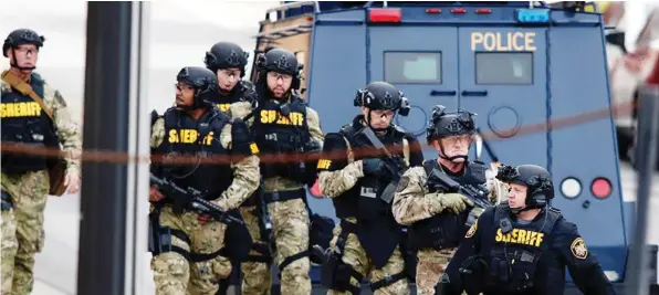  ??  ?? COLUMBUS, Ohio: Law enforcemen­t officials are seen outside a parking garage on the campus of Ohio State University as they respond to an active attack yesterday. —AFP