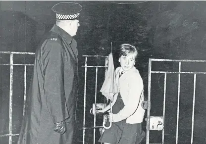  ??  ?? A pupil leaves St John’s School gate, Harefield Road, Dundee, in 1967, when a class was held up at gunpoint. The teacher was shot and later died in hospital. It is one of the crimes to feature in an episode of Murdertown, which will be aired on the Crime and Investigat­ion channel.