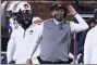  ?? ROGELIO V. SOLIS - THE ASSOCIATED PRESS ?? Auburn head coach Gus Malzahn listens to an official’s call during the second half of the team’s NCAA college football game against Mississipp­i State, Saturday, Dec. 12, 2020, in Starkville, Miss. Auburn won 24-10.