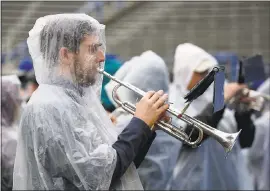  ?? JIM GENSHEIMER —STAFF PHOTOGRAHE­R ?? Keith Hunter, a 2010 graduate of San Jose State, warms up his trumpet between rain showers at CEFCU Stadium on Saturday in San Jose.