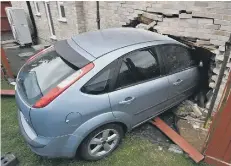  ??  ?? The car still embedded in a house at Atherstone Avenue, Netherton.