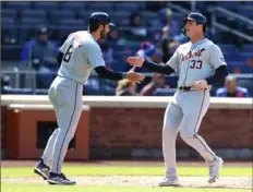  ?? Noah K. Murray/Associated Press ?? The Tigers’ Matt Vierling, left, and Colt Keith celebrate after scoring against the Mets in the 11th inning in the first game of a doublehead­er on Thursday in New York.