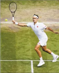  ?? Matthias Hangst / Getty Images ?? Roger Federer of Switzerlan­d plays a forehand in his quarterfin­al contest against Japan’s Kei Nishikori at Wimbledon on Wednesday.