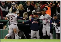  ?? AP/DAVID J. PHILLIP ?? Alex Bregman (2) celebrates after scoring on a single by Carlos Correa during the sixth inning of the Astros’ 7-2 victory over the Boston Red Sox in Game 1 of the American League Championsh­ip Series.