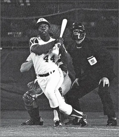  ?? HARRY HARRIS/AP ?? Hank Aaron eyes the flight of the ball after hitting his 715th career homer in 1974 against the Los Angeles Dodgers.