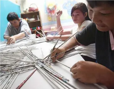  ??  ?? at the Long Laput Community rehabilita­tion Centre, ‘slow learners’ are taught skills such as weaving baskets from strips of old newspaper.