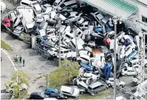  ?? PHOTOS: REUTERS ?? Vehicles damaged by Typhoon Jebi are piled up in Kobe, western Japan yesterday.