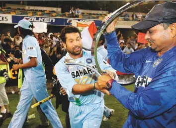  ?? Reuters ?? India’s Sachin Tendulkar celebrates with team’s assistant coach Lalchand Rajput after winning the ODI tri-series against Australia in Brisbane in 2008.