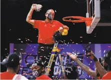  ?? Jamie Squire / Getty Images ?? Head coach Kelvin Sampson relishes the traditiona­l net celebratio­n after Houston grabbed the Midwest Region title.