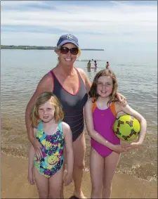  ??  ?? Enjoying the sunshine on Myrtlevill­e Beach, Co. Cork: Mother Jennifer with daughters Robyn and Hazel from Inniscarra. Photo: Michael Mac Sweeney/Provision