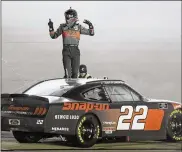  ?? MARK HUMPHREY / AP ?? Austin Cindric celebrates after winning the NASCAR Xfinity Series race Friday in Sparta, Ky.