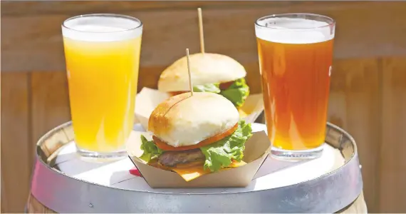  ?? JIM WELLS ?? Beers and burgers form a mouth-watering display at Citizen Brewing Company in northeast Calgary.