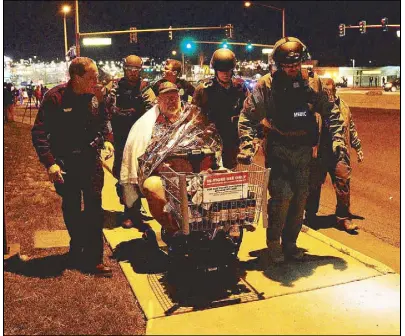  ?? REUTERS ?? Patrick Carnes is evacuated in a cart by SWAT medics from the scene of a shooting at a Walmart store where Carnes was shopping in Thornton, Colorado on Wednesday.