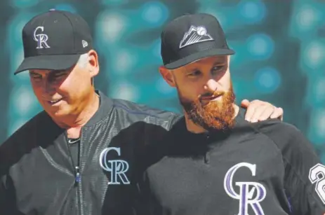  ?? David Zalubowski, The Associated Press ?? Rockies manager Bud Black confers with newly acquired catcher Jonathan Lucroy during batting practice last week. The veteran has reached the playoffs three times in his career and has often been in a late-season playoff chase.