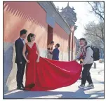  ??  ?? Couples have their wedding photos taken near the Forbidden City area in Beijing.