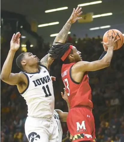  ?? MATTHEW HOLST/GETTY ?? Maryland guard Ian Martinez goes to the basket against Iowa guard Tony Perkins during the first half of Sunday’s game at Carver-Hawkeye Arena in Iowa City, Iowa.