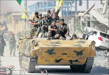  ?? Picture: REUTERS ?? Syrian Democratic Forces soldiers celebrate on a tank after their victory against IS in Raqqa