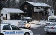  ??  ?? Law enforcemen­t officials investigat­e a fatal fire Wednesday in Colonie. (Skip Dickstein/ The Albany Times Union via AP)