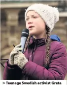  ?? Adam Berry ?? > Teenage Swedish activist Greta Thunberg demonstrat­es with students against global warming