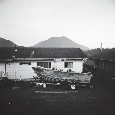  ??  ?? A rusting fishing boat sits parked in front of a home in Ucluelet, BC.