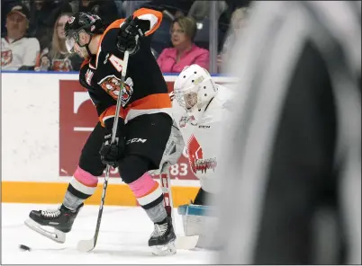  ?? NEWS PHOTO RYAN MCCRACKEN ?? Medicine Hat Tigers winger Ryan Jevne deflects a shot on Moose Jaw Warriors goaltender Brodan Salmond during Western Hockey League action at the Canalta Centre on Saturday.