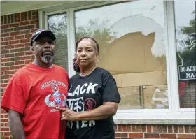  ?? DAVID GURALNICK/DETROIT NEWS VIA AP, FILE ?? Eddie Hall Jr. and his wife, Candace, stand in front of the broken front window of their Warren, Mich., home, on Sept. 10. Some experts say political and social unrest as well as the coronaviru­s pandemic has taken a disproport­ionate physical and financial tolls on Black people, resulting in increased anxiety levels among African Americans.