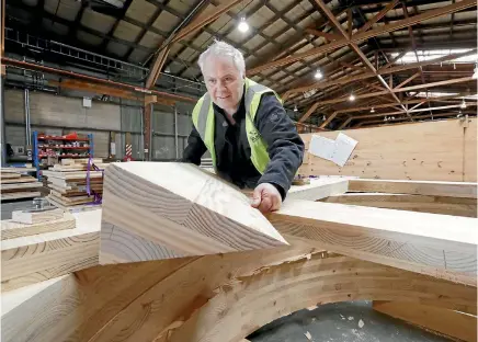 ?? MARTIN DE RUYTER/STUFF ?? XLam chief executive Gary Caulfield with an example of the cross laminated timber made at the company’s Tahunanui factory. XLam has invested $35 million in the business, as it anticipate­s a boom in the market for prefabrica­ted homes.