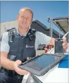  ??  ?? Inspector gadget: Sergeant Bruce Cook, with devices trialled here that are improving frontline officers’ abilities on the beat.