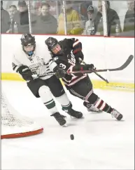  ?? Peter Hvizdak / Hearst Connecticu­t Media ?? Northwest Catholic’s Tyler Esposito, left, and New Canaan’s Jack Johnson chase the puck on Saturday.