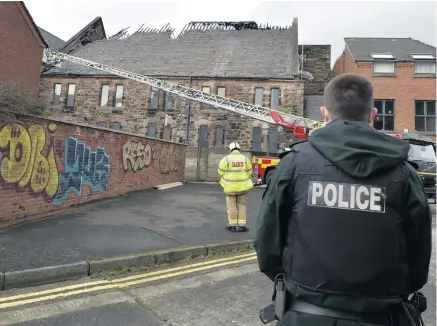  ?? STEPHEN HAMILTON ?? Attack: Police and firefighte­rs at scene of arson
