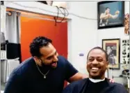  ?? AP PHOTO BY DAMIAN DOVARGANES ?? In this Sunday, March 11 photo, Barber Eric Muhammad, owner of A New You Barbershop, left, jokes with regular customer Marc M. Sims before measuring his blood pressure in Inglewood.