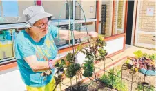  ??  ?? LEFT: Resident Maureen Schulz enjoys being back in the garden at Carinity Karinya Place.