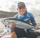  ?? Ethan Swan cradles a thumping longtail or northern bluefin tuna. ??