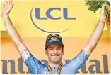  ?? ?? Canadian rider Hugo Houle celebrates on the podium after winning the 16th stage of the 109th edition of the Tour de France cycling race in southern France on July 19, 2022.