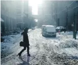  ?? GIORDANO CAIMPINI, CP ?? A pedestrian walks along snow-covered street in Toronto on Monday.
