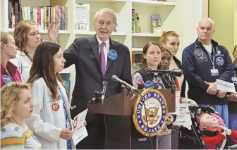  ?? STAFF PHOTO BY FAITH NINIVAGGI ?? ‘AN ABOMINATIO­N’: U.S. Sen. Edward J. Markey calls for an extension to the Children’s Health Insurance Program. Doctors, families, patients, nurses and residents flank him at Boston Children’s Hospital.