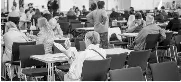  ??  ?? People wait in an exhibition hall serving as a shelter as evacuation measures are under way in Frankfurt am Main, western Germany. — AFP photo