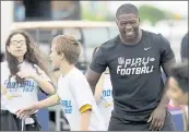  ?? DAVID J. PHILLIP — ASSOCIATED PRESS ?? NFL Draft prospect Roquan Smith, right, laughs during a Play Football Clinic Wednesday in Arlington, Texas.