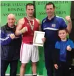  ??  ?? Newly crowned Irish Novice Champion Damien O Boyle of the Sean Mc Dermott Boxing Club with his team, James Kelly and James Dowell.